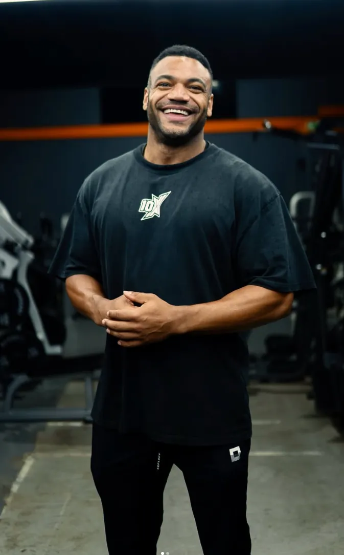 Miles Addison smiling in the gym, wearing a 10X Athletic shirt