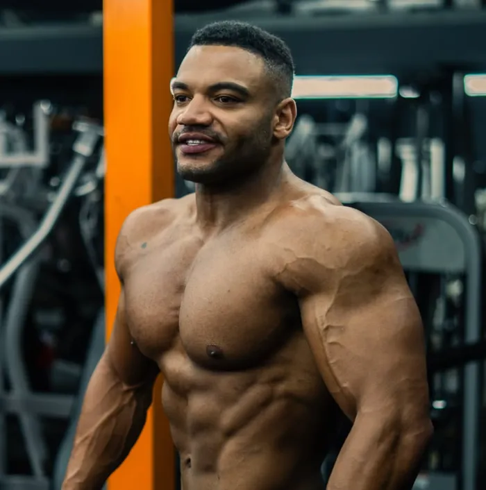 Miles Addison in the gym, showing his physique